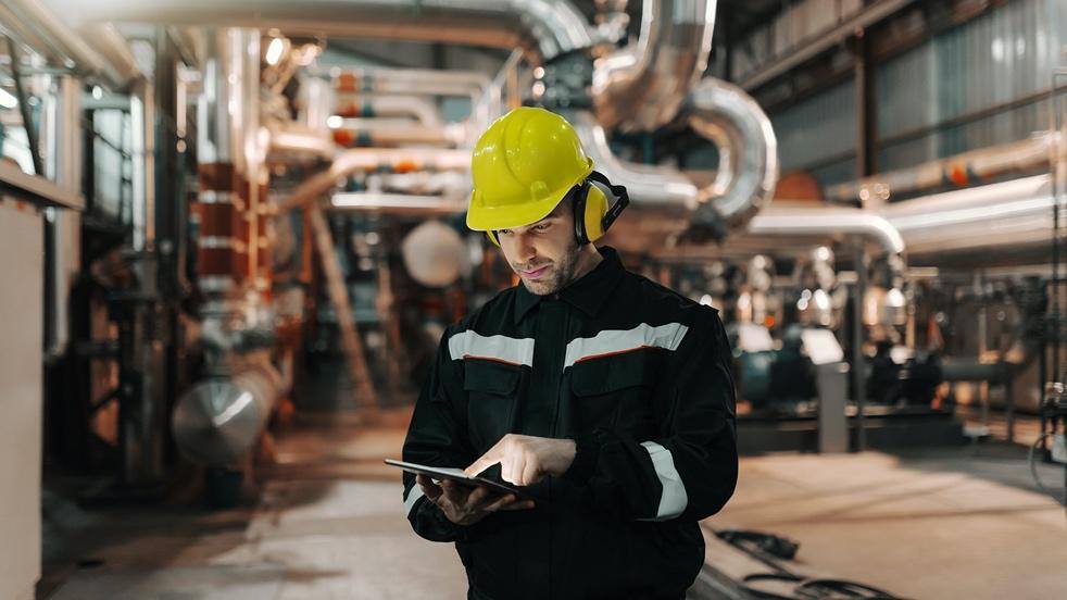 A person wearing a hard hat and earmuffs