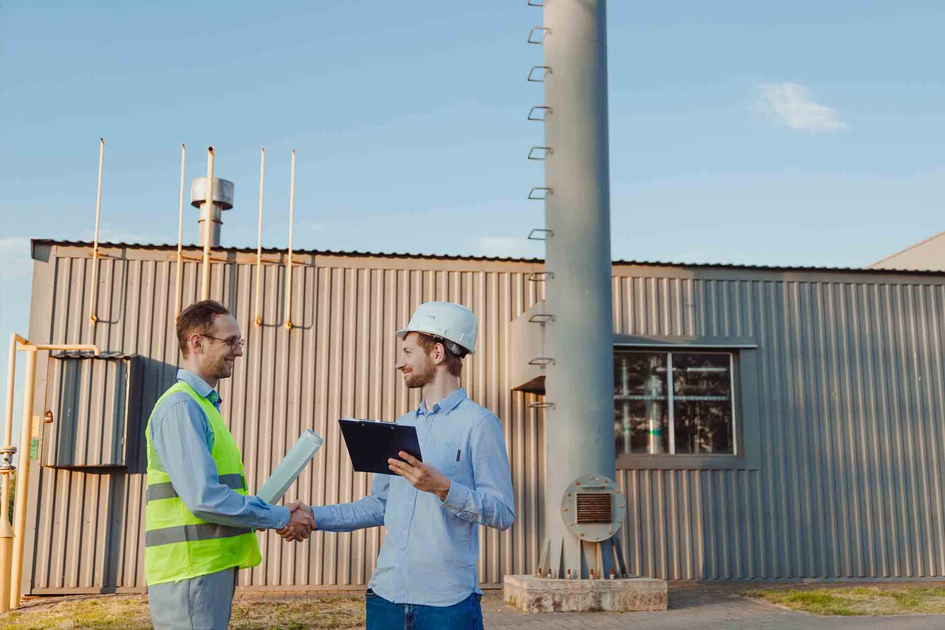 Two constructions workers shaking hands in an construction site