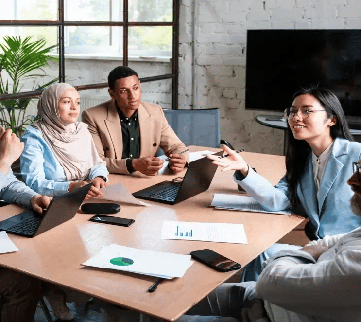 Employees using room booking software to reserve an office for a meeting, ensuring efficient space utilization