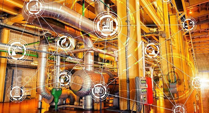 A smart factory with interconnected pipes and digital icons representing various industrial technologies.