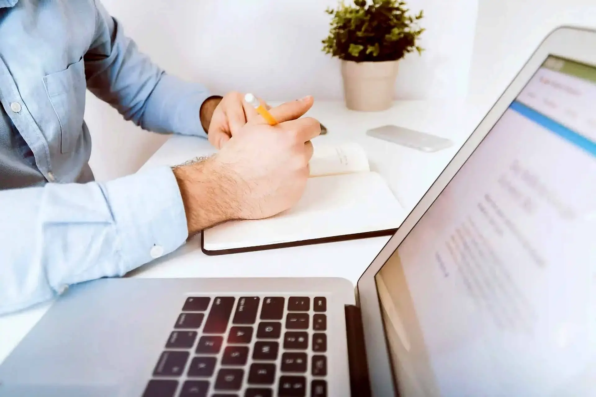 Accountant working on lease agreements with documents, computer, and financial reports.