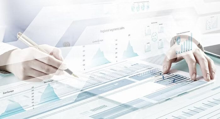 Close-up of hands analyzing charts and graphs on a digital interface, representing data visualization