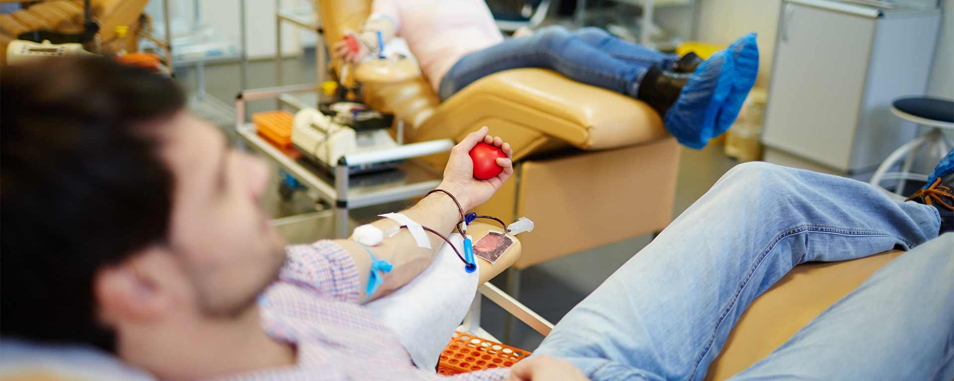 Donor lying on a medical chair donating blood