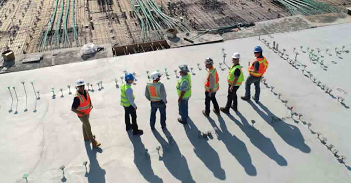 Project managers reviewing work orders and coordinating tasks on a construction site.