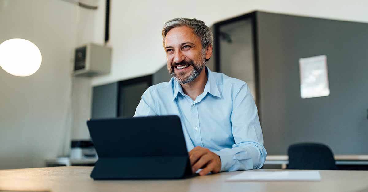 An employee using desk booking software in a workplace