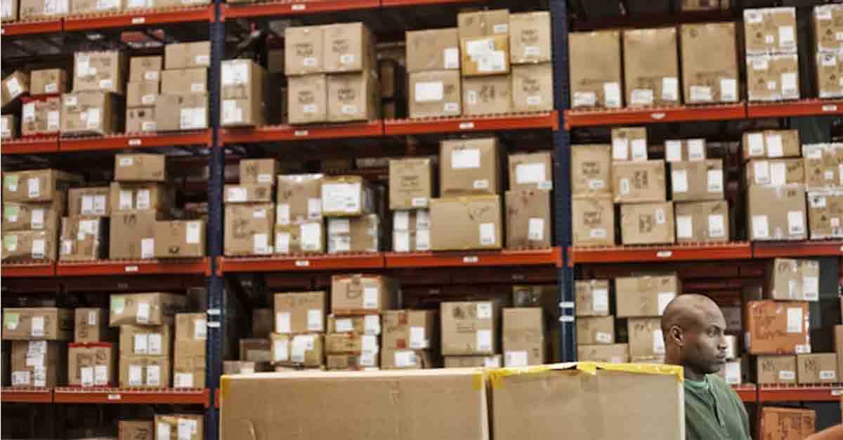 warehouse-worker-checking-inventory-managing-assets-min