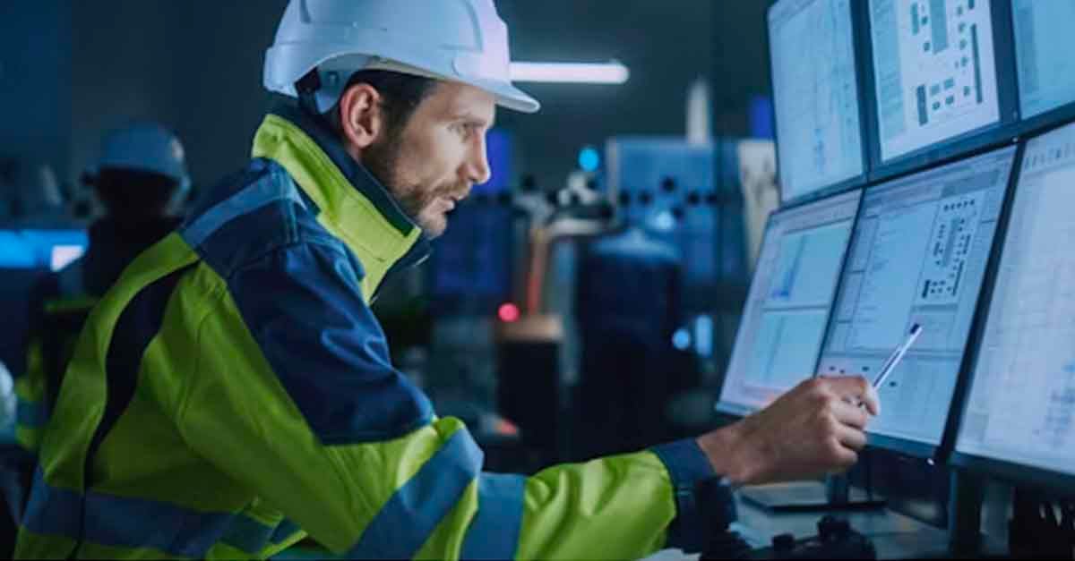 Engineer in a control room monitoring multiple screens