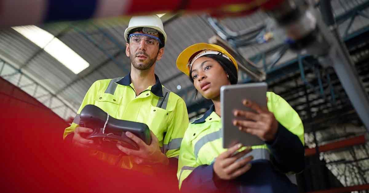 Two engineers working in safety gear