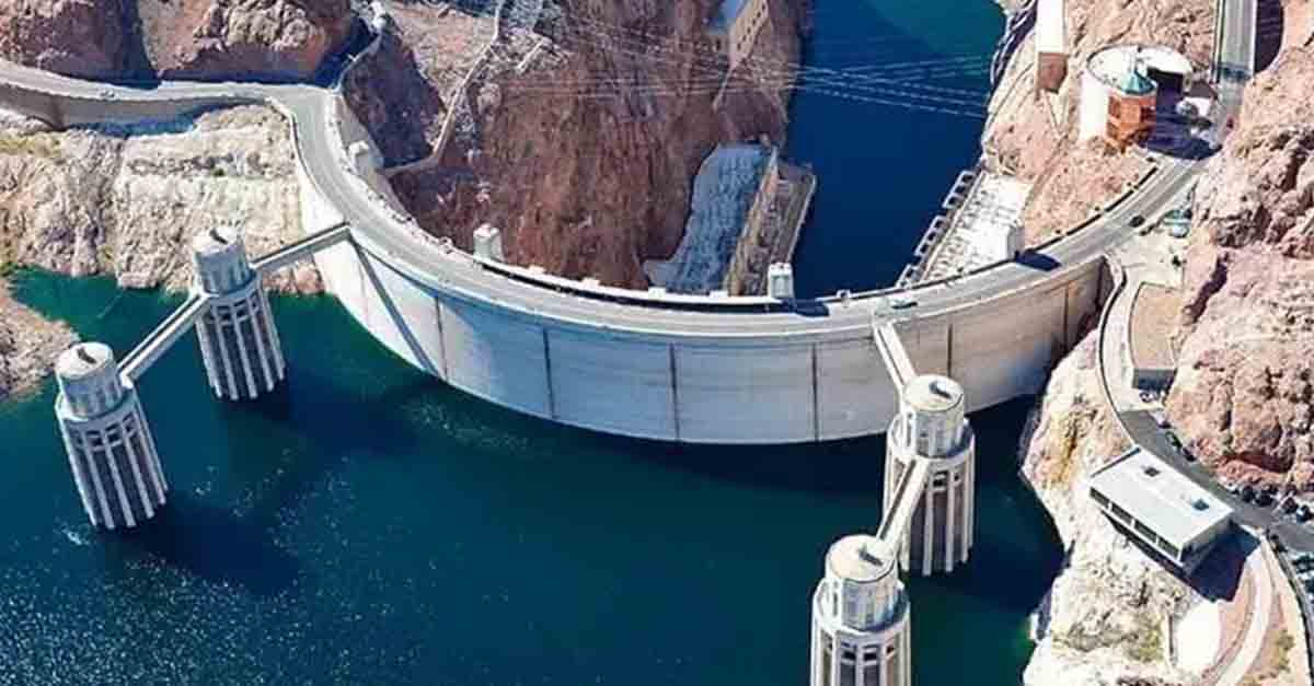 Aerial view of the Hoover Dam with water and surrounding rocky landscape