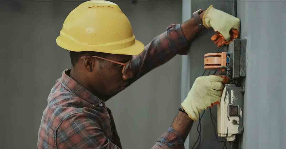 A factory worker performing a routine maintenance check on equipment.