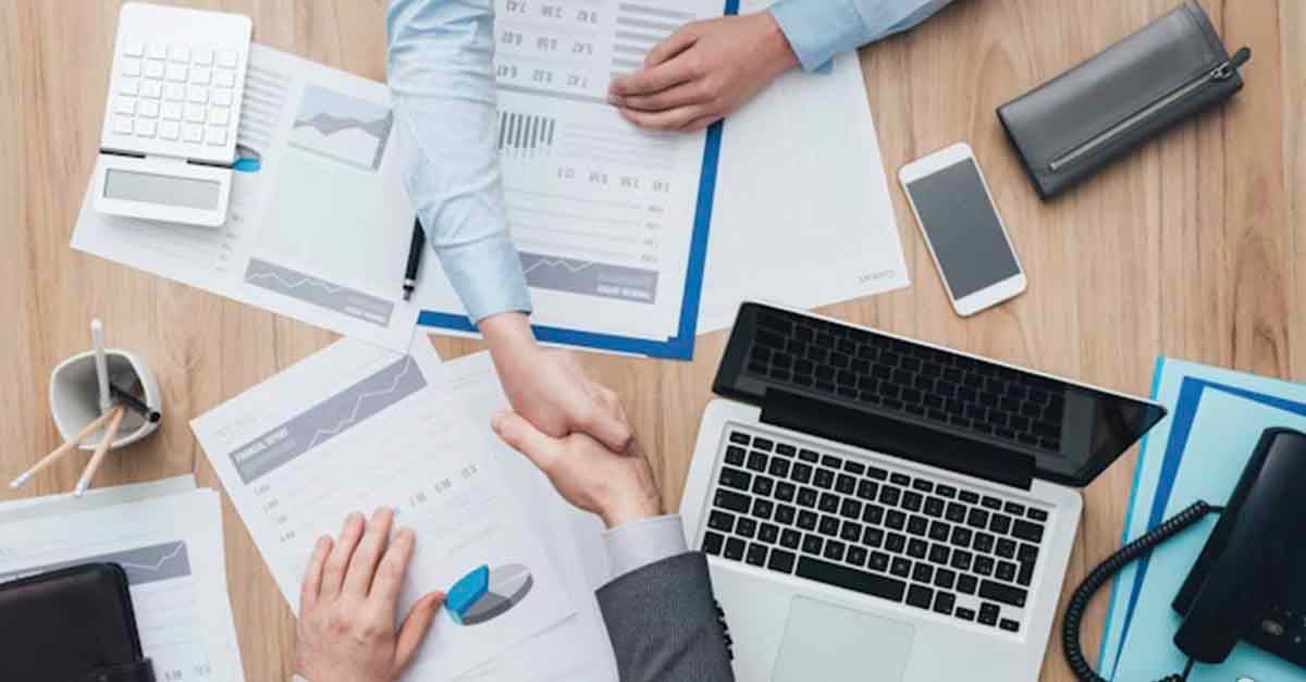 Two persons handshake in a business meeting setting