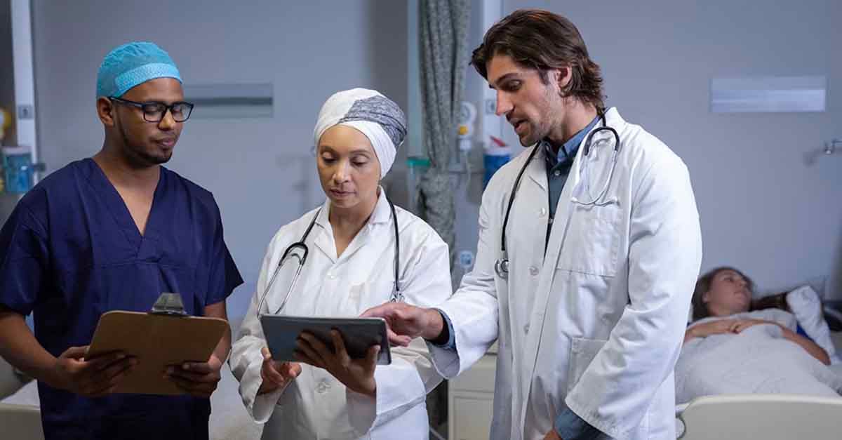 Doctors discussing patient information in a hospital room