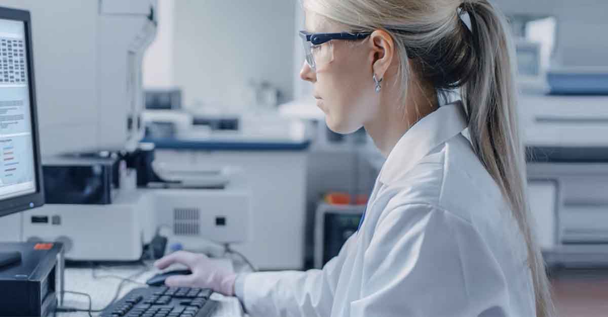 Scientist analyzing data on a computer in a laboratory