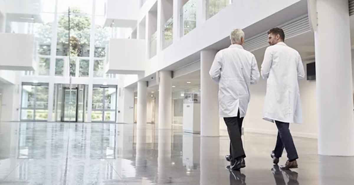 Two doctors walking in a modern hospital hallway