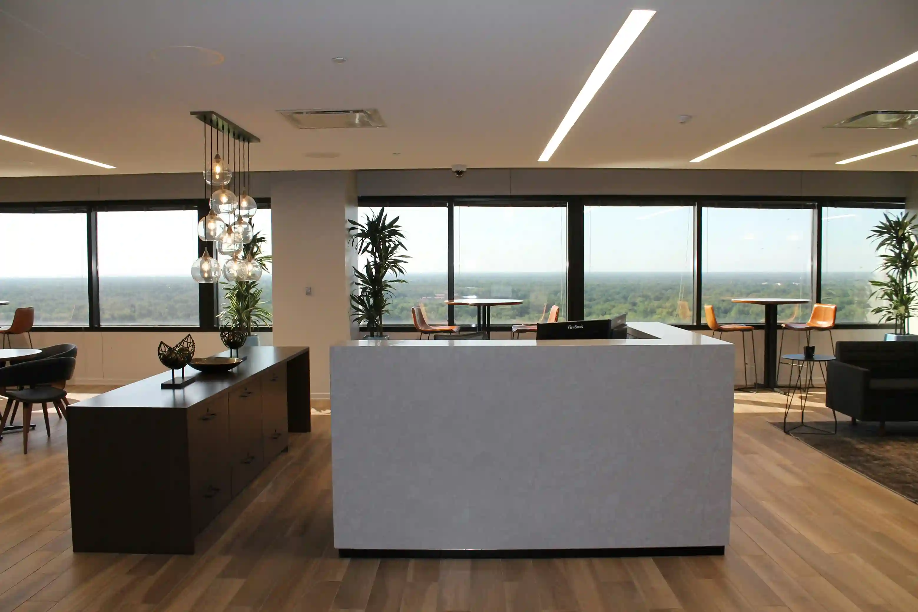 Modern office reception area with large windows and scenic view