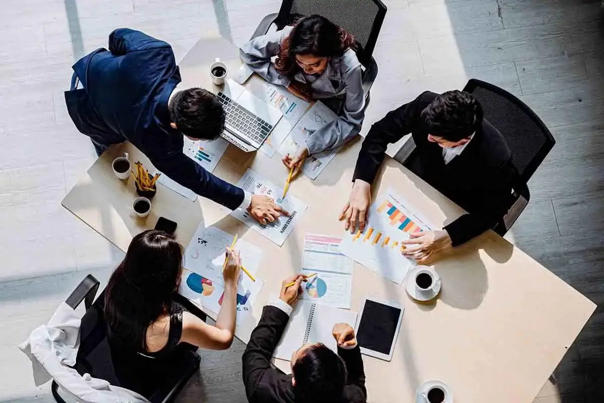 A group of colleagues engaged in a discussion around a table in a office