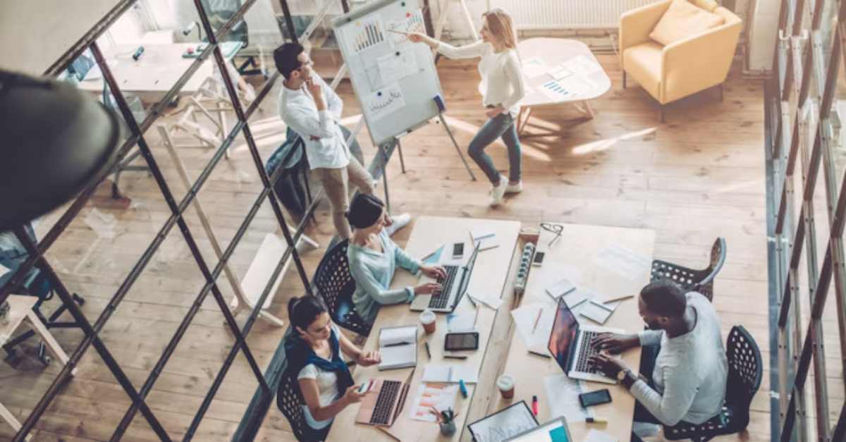 People working on laptops at office with a space software solution